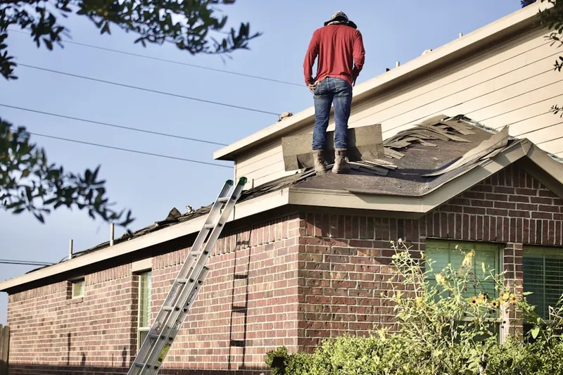 Professional roofer working on a residential roof in Polaris North